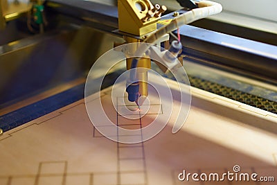 Plywood laser cutting process close up Stock Photo