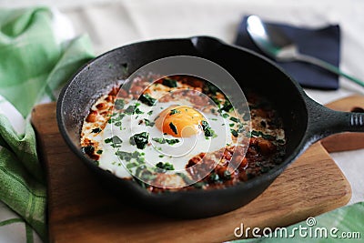 Poached egg in tomato sauce, paprika and spices, arabic shakshouka Stock Photo