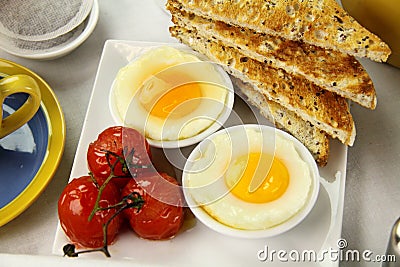 Poached Eggs And Tomatoes Stock Photo