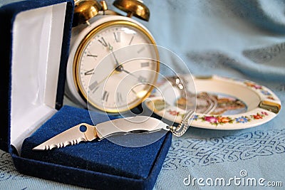 Pocket folding knife vintage analog clock beautiful ashtray Stock Photo