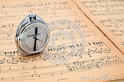 Pocket metronome on an ancient music score Stock Photo