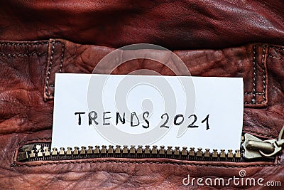 In the pocket of a red leather jacket under the zipper is a leaflet with the text trends 2021 Stock Photo