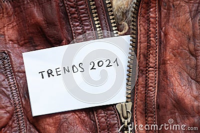 In the pocket of a red leather jacket under the zipper is a leaflet with the text trends 2021 Stock Photo
