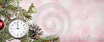 Pocket watch on Christmas tree branch on pink background Stock Photo