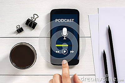 Podcast concept on smart phone screen with office objects Stock Photo