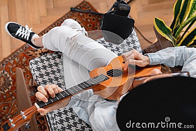 podcaster creates content, happy woman musician with guitar records podcast with microphone and headphones, Caucasian Stock Photo