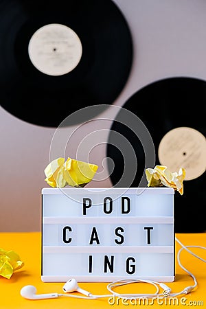 Podcasting lettering and vinyl record albums, headphones, crumpled paper in minimalistic isometric style. Trendy colors. Grey and Stock Photo