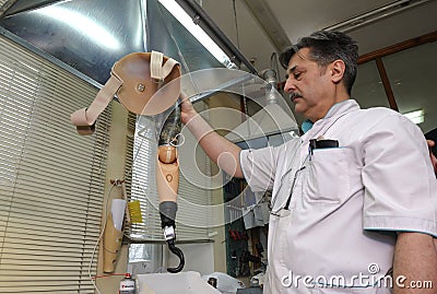 Podiatrist showing a new artificial limb for participants of Russian-Ukrainian war Editorial Stock Photo