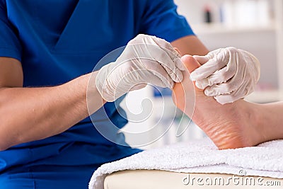 The podiatrist treating feet during procedure Stock Photo