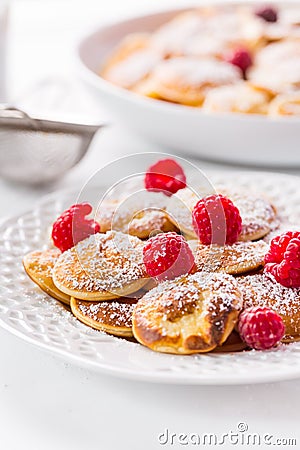 Poffertjes - small Dutch pancakes with fresh raspberries Stock Photo