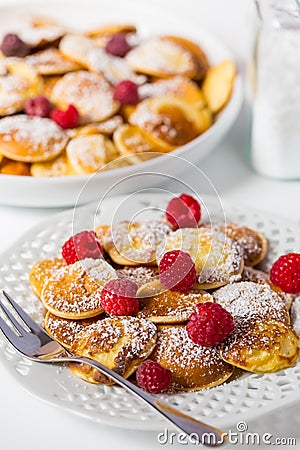 Poffertjes - small Dutch pancakes with fresh raspberries Stock Photo