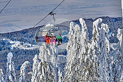 Poiana Brasov, Romania -09 January 2019: Skiers on the ski lift, skiers on slope in Romanian ski resort in sunny day, Poiana Editorial Stock Photo