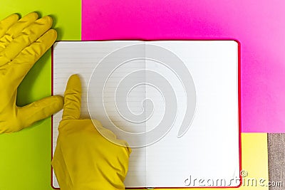 Point gloved finger to a blank magazine page. Bright pink and yellow background. hazard Stock Photo