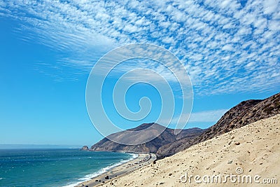 Point Mugu seen from Sandy Dune vista under beautiful sunny cumulus cloudscape in Southern Stock Photo