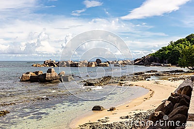 Pointe Cocos coastline with granite rocks sticking out from the ocean, Praslin Island, Seychelles Stock Photo