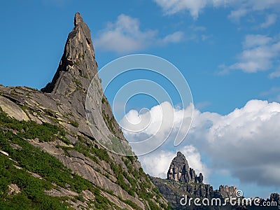 Pointed cliff, a misty mountainside. Ghost rocks. Awesome scenic mountain landscape with big cracked pointed stones closeup in Stock Photo