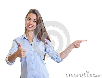 Pointing businesswoman with long dark hair and thumb up Stock Photo
