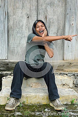 Pointing long haired teenager Stock Photo