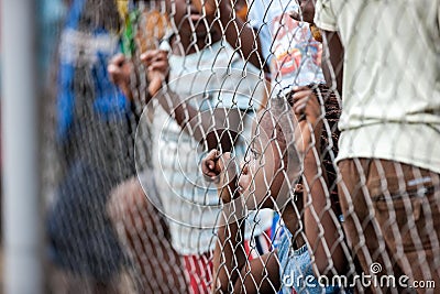 POINTNOIRE/CONGO - 18MAY2013 - African children behind iron net Editorial Stock Photo