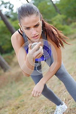 Poised lady with stopwatch Stock Photo