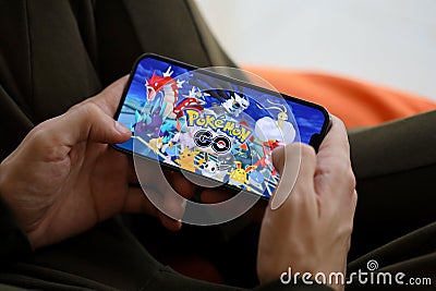 Pokemon GO mobile iOS game on iPhone 15 smartphone screen in male hands during mobile gameplay Editorial Stock Photo