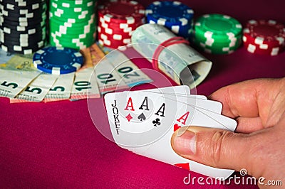 Poker cards with five of a kind combination. Close up of gambler hand takes playing cards in casino Stock Photo