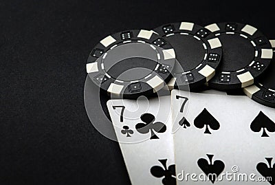 Poker cards with one pairs winning combination in casino. Chips and cards on the black table Stock Photo