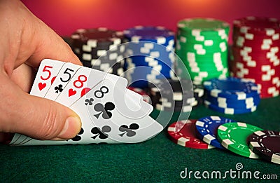 Poker cards with two pairs combination. Close up of gambler hand takes playing cards in poker club Stock Photo