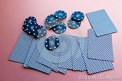 Poker chips and cards on a pink background. The game of poker. Chip dealer Stock Photo