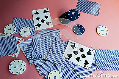 Poker chips and cards on a pink background. The game of poker. Gambling. Editorial Stock Photo