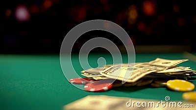 Poker chips and dollars lying on green table, poker and blackjack casino games Stock Photo