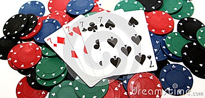 Poker chips and four sevens Stock Photo