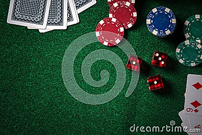 Poker chips and gamble cards on casino green table with low key Stock Photo