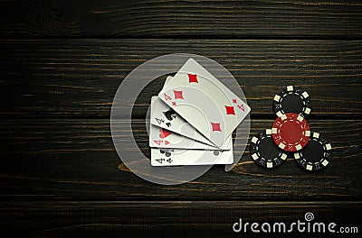 Poker game with four of kind combination. Chips and cards on the black vintage table. Successful and maximum win. Copy space Stock Photo