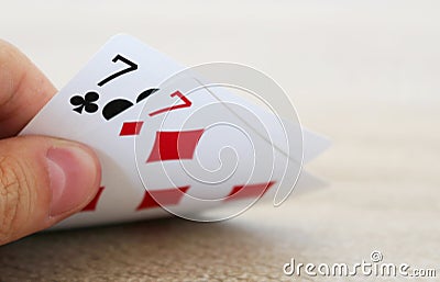 Poker game with hand of two lucky sevens Stock Photo