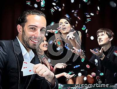 Poker players sitting around a table Stock Photo