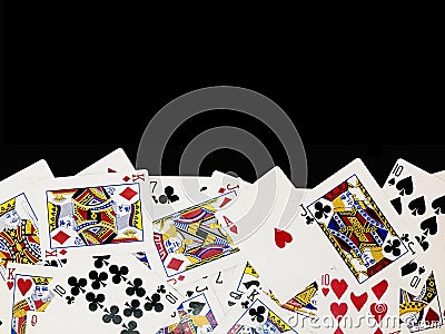 Poker playing cards is arranged in the lower half of the black background. Stock Photo