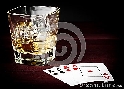 Poker playing cards near wiskey glass Stock Photo