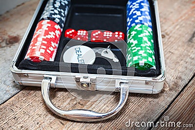 Poker set in metallic case on wooden floor Stock Photo