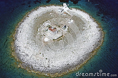 Pokonji Dol lighthouse on little islet from air Stock Photo