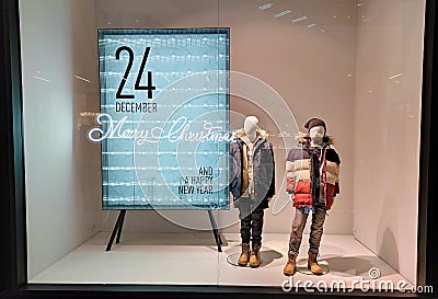 Poland, Bydgoszcz - December 23, 2021: Children's mannequins near the Christmas stand in the shop window Editorial Stock Photo