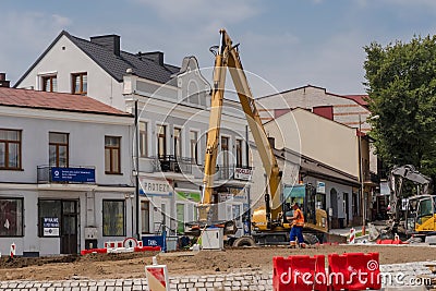 Poland Ostrowiec Swietokrzyski July 11, 2024 11:13 AM .CAT excavator - finishing works on the construction of a roundabout. Editorial Stock Photo