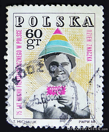 Poland postage stamp shows child holding symbolic stamp, 75 years philatelic movement in Poland, Krakow, T. Michaluk, circa 1968 Editorial Stock Photo