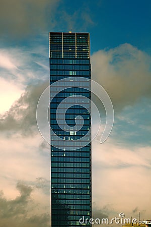Skyscraper of glass and steel in the form of a parallelepiped with a tower Stock Photo