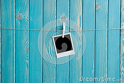 Polaroid picture with black space on the blue wooden background Stock Photo