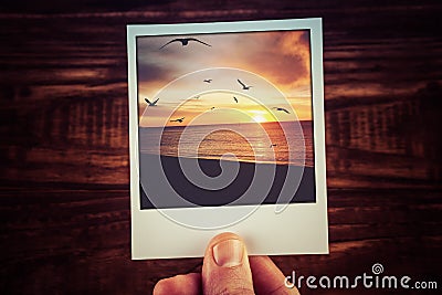 Polaroid postcard of beautiful sunset over ocean coastline with Stock Photo
