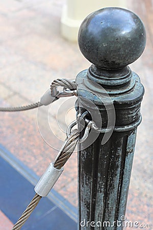 pole with metal restraining rope. Barrier, enclosed VIP area, protected entrance, private event, restrict area barricade pole Stock Photo