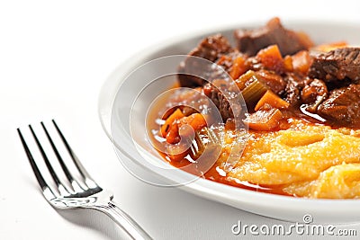 Polenta and beef stew on a plate. High quality photo. Stock Photo