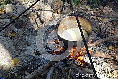 The polenta boils in the boiler. Stock Photo