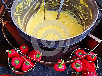 Polenta at the cauldron and red capia peppers - romanian traditional Stock Photo